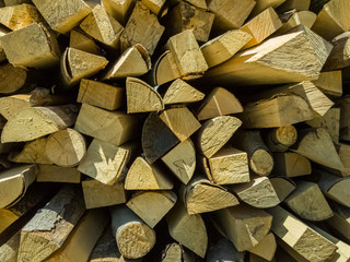 Small pieces of firewoods neatly stacked as combustible for winter