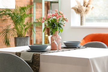Bouquet of flowers on table in dining room