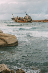 rusty ship in water of mediterranean sea against sky