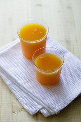 glass of orange juice on a wooden table. Fresh orange juice.
