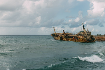 Fototapeta na wymiar rusty ship in blue water of mediterranean sea