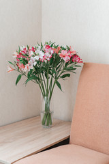 Bouquet Of Alstroemeria Flowers In Glass Vase on table. Alstroemeria flowers background. Flowers Alstroemeria.