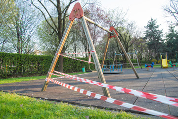 No entry barrier tape in a playground, due to the quarantine restrictions activated to combat the Coronavirus pandemic