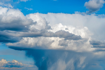 Sun is higher than a rain cloud over the sea. Natural background.