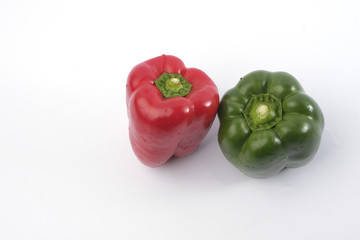 Green and red bell pepper on white background