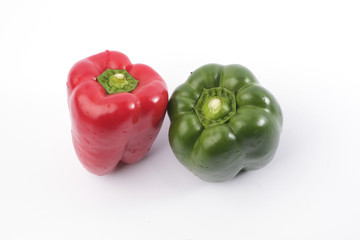 Green and red bell pepper on white background