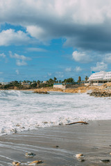 White building near Mediterranean sea against blue and cloudy sky in Cyprus