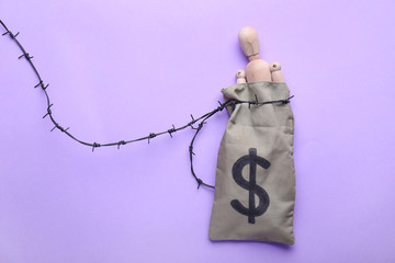 Money bag with human figure and barbed wire on color background