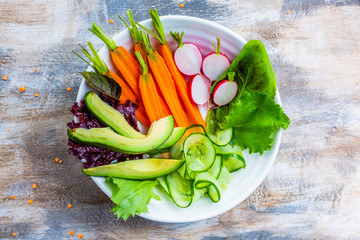 Radishes and raw seasonal vegetables and ingredients for the Buddha bowl. Vegetarian food.