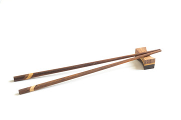 Wooden chopsticks isolated on white .