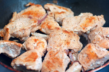 cooking chicken in a pan , delicious pieces of fillet