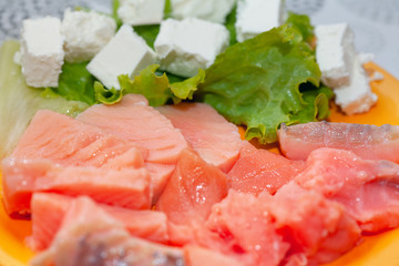 sliced salmon and cheese on a plate