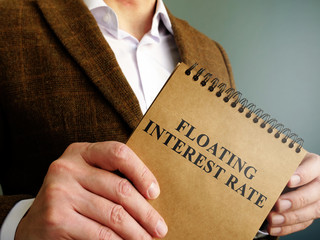 Man holds information about floating interest rate.