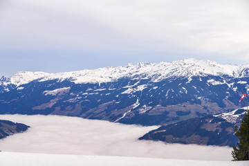 Snow tops of the Alps, a river of fog steaming in the valley