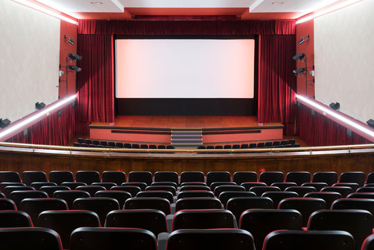 Inside of movie theatre with empty seats and stage