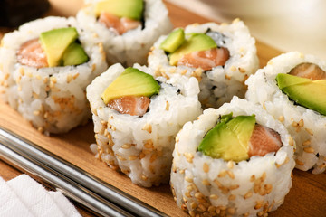 Salmon and avocado pear uramaki sushi rolls