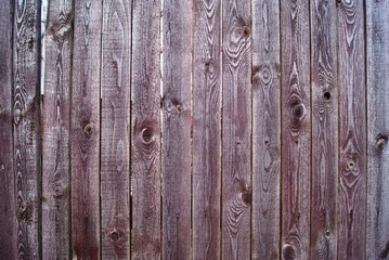 A fragment of a fence made of wooden boards with a beautiful wood texture