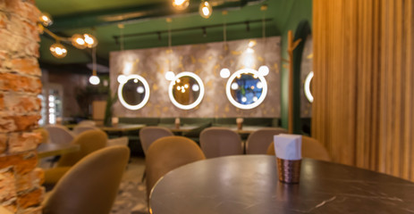 Cute restaurant interior with sofas and wooden tables