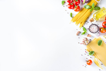 Italian food ingredients for  cooking Spaghetti Pasta. Raw spaghetti pasta with various ingredient - onion, tomatoes, garlic, basil, parsley, cheese, olive oil. On white table background, flatlay copy