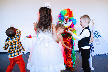 Children play with a clown