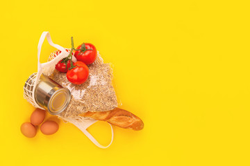 Food packaging on yellow background. Quarantine food delivery home. Flatlay banner with copyspace.