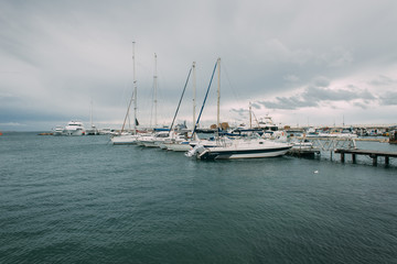 white yachts in mediterranean sea against sky with clouds
