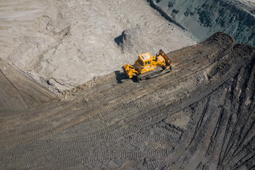 Aerial view of industrial mineral open pit mine. Opencast mining quarry with lots of machinery at work. Drone view from above.