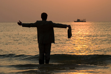 
Businessman by the sea at sunset