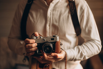 Portrait of a young men taking a photo with a vintage camera.