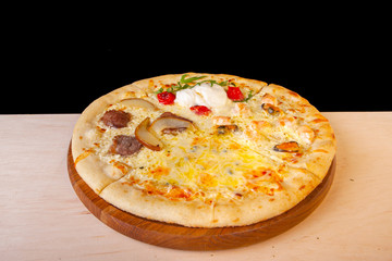 fresh pizza with ingredients in it on a wooden board