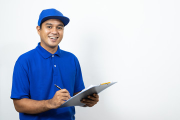 Asian Delivery man signing clipboard receipt of delivery package on isolated white background.
