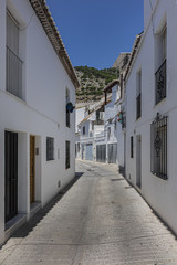 Fototapeta na wymiar Beautiful view of Mijas Picturesque Narrow Street. Mijas - Spanish hill town overlooking the Costa del Sol, not far from Malaga. Mijas known for its whitewashed buildings. Mijas, Andalusia, Spain.