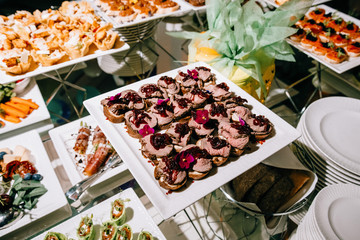 Beautifully decorated catering banquet table with different food snacks