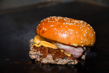 Fresh melting burger ready to eat during fast food festival.