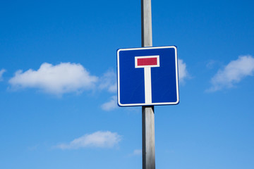 International traffic sign 'Dead end' (of street or road). Blue sky with small clouds are on...