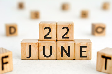 June 22 - from wooden blocks with letters, important date concept, white background random letters...