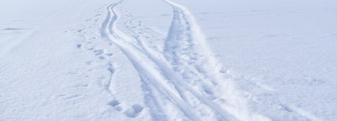 Fototapeta na wymiar Tire tracks in the snow. Snowy road.