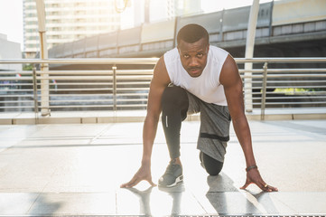 Fototapeta na wymiar African black people Young Athlete man in running start pose