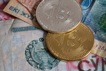 golden bitcoin coin on uzbekistan som close up macro. Electronic crypto currency on uzbek value money