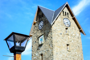 Clock tower of the civic center of Bariloche, Argentina. A sunny day in March.