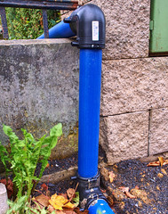 Blue steel water branch pipe installation in excavated trench