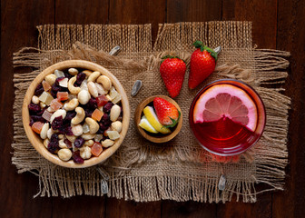 cocktail of red bitter and lemon with dried fruit and dehydrated snack