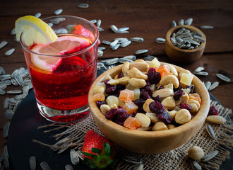 cocktail of red bitter and lemon with dried fruit and dehydrated snack