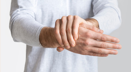 Man holding his hand and feels severe pain