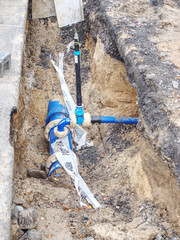 Plastic and steel pipes and valves underground. Repairing of system