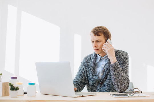 A Young Man, A Manager Of A Pharmaceutical Company, Talks On The Phone In His Office.