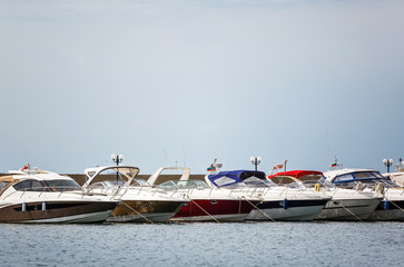 Yachts parked near a pear. Summer seascape