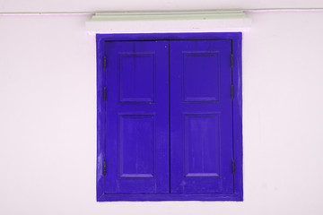 Blue Wooden door on white wall texture background - abstract surface with copy space                                