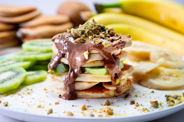 Fresh fruit pancakes with kiwi and banana and chocolate