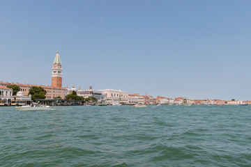 Street of Venice in summer time. Roof, sea canal in sunny day. Old city, ancient buildings. Popular tourist destination of Italy. Europe. Venetian canal without  people. Palazzo Ducale. Doge's Palace.